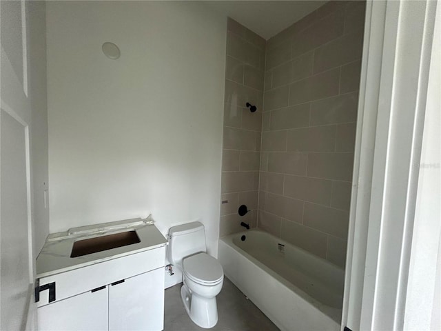 full bathroom with tiled shower / bath, vanity, and toilet