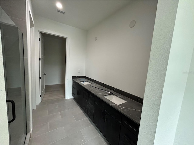 bathroom featuring vanity, tile patterned floors, and an enclosed shower