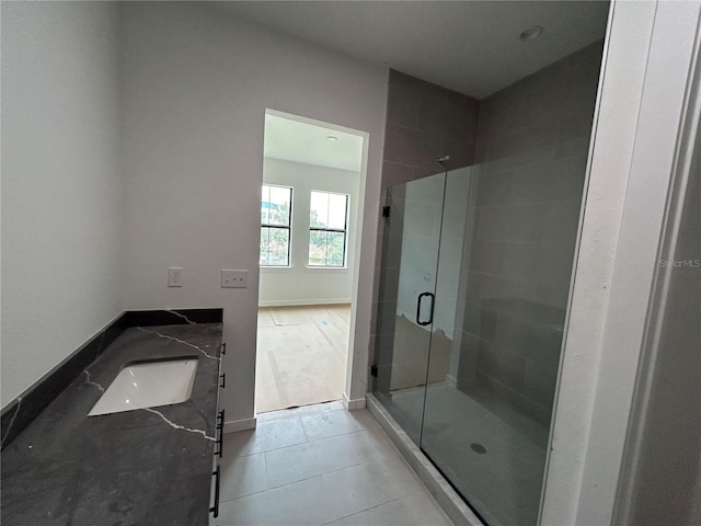 bathroom with tile patterned floors, vanity, and a shower with shower door