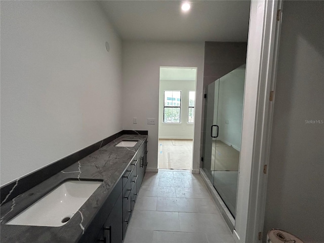 bathroom featuring vanity, tile patterned floors, and walk in shower