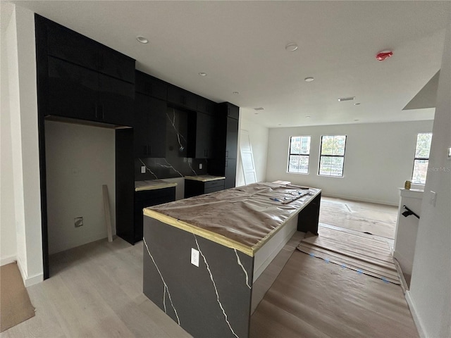 kitchen with a kitchen island and light wood-type flooring