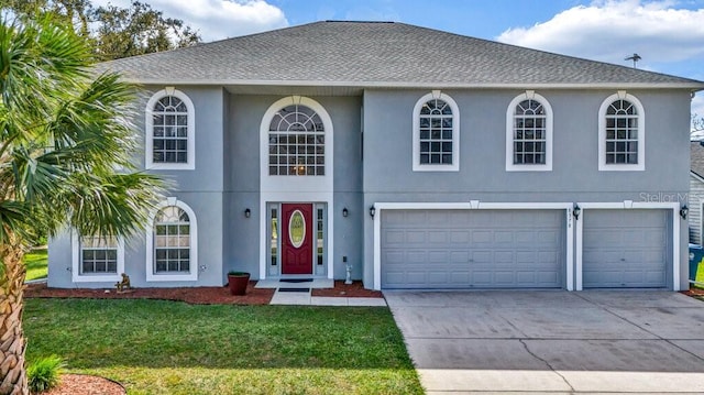 view of front of property with a front yard and a garage