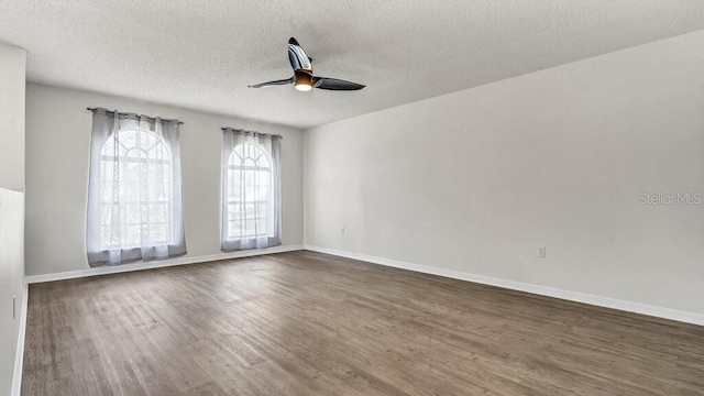 spare room featuring a textured ceiling, ceiling fan, and dark hardwood / wood-style flooring