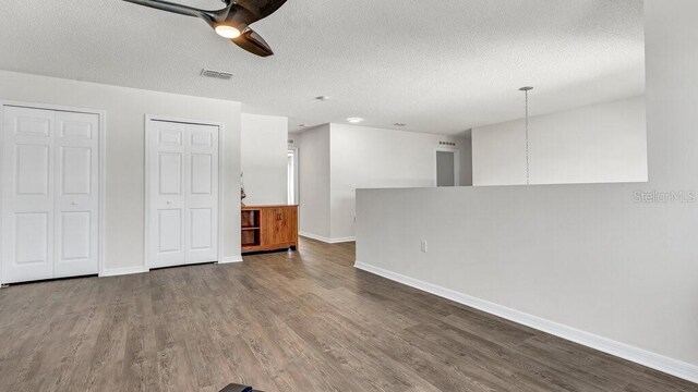 spare room featuring ceiling fan, wood-type flooring, and a textured ceiling