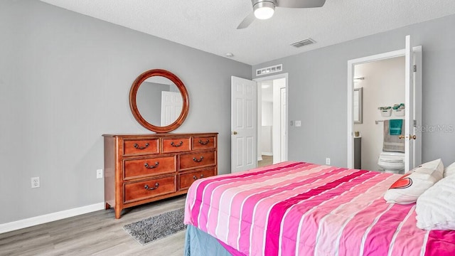 bedroom featuring connected bathroom, ceiling fan, a textured ceiling, and light hardwood / wood-style floors