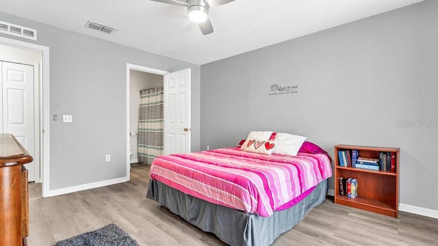 bedroom featuring ceiling fan, a textured ceiling, and light hardwood / wood-style floors