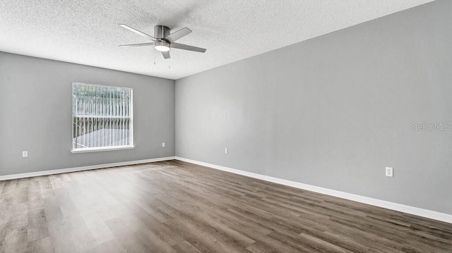 empty room featuring a textured ceiling, hardwood / wood-style flooring, and ceiling fan