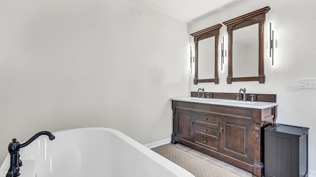 bathroom with vanity and a tub