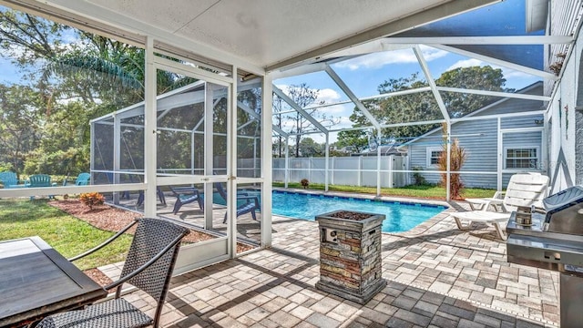 view of swimming pool featuring a patio and a lanai