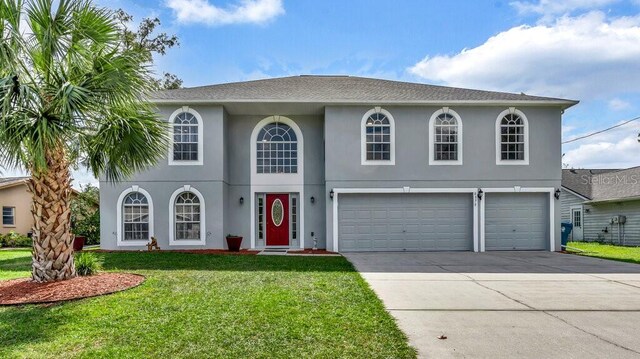 view of front of house featuring a front yard and a garage