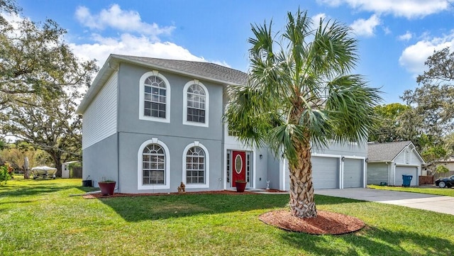 view of front of property featuring a front lawn and a garage