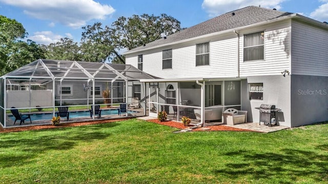 rear view of house featuring a sunroom, a lanai, a lawn, and a patio area