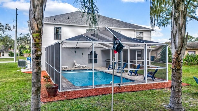 back of house with central AC unit, a patio, a lawn, and glass enclosure