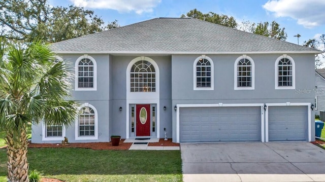 view of front facade with a front yard and a garage