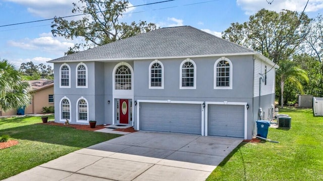 view of front facade featuring central AC, a garage, and a front lawn