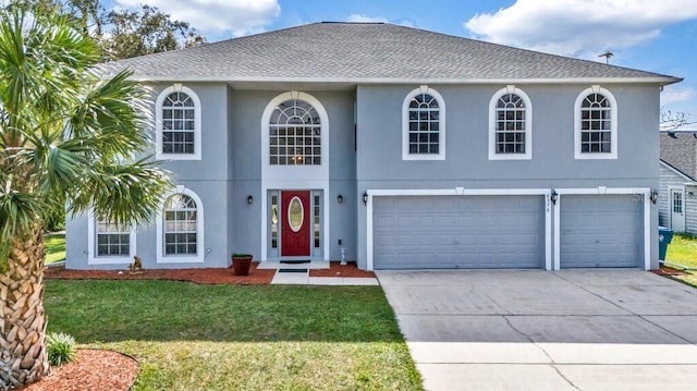 view of front of house featuring a front lawn and a garage