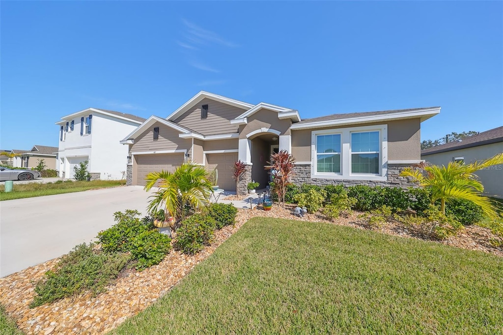 view of front of property with a front yard and a garage