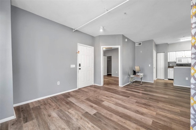 unfurnished living room featuring hardwood / wood-style flooring