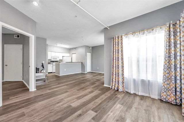 unfurnished living room with wood-type flooring