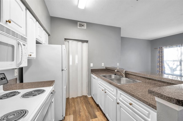 kitchen with kitchen peninsula, light wood-type flooring, white appliances, sink, and white cabinetry