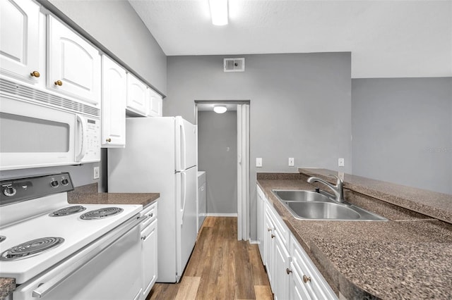 kitchen featuring white cabinets, white appliances, and sink