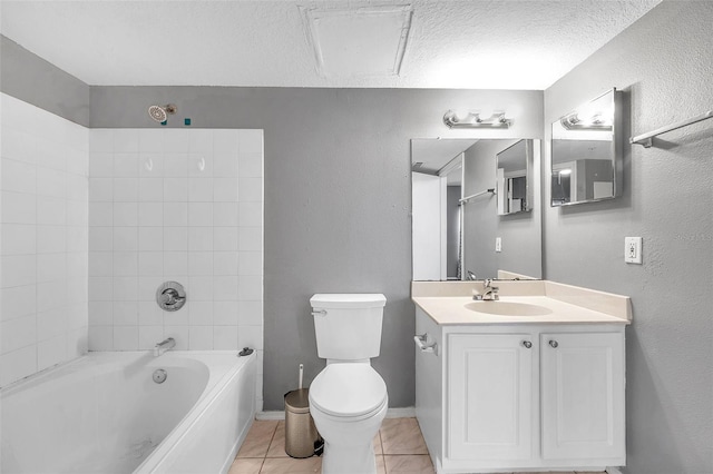 full bathroom with vanity, tile patterned flooring, tiled shower / bath combo, toilet, and a textured ceiling