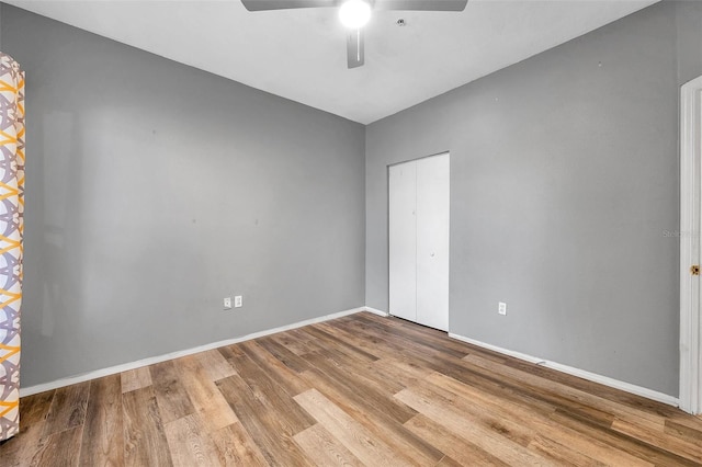 spare room featuring hardwood / wood-style floors and ceiling fan