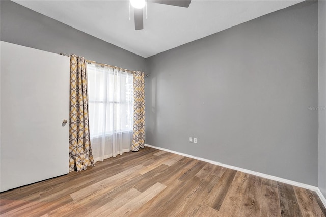 spare room featuring light hardwood / wood-style floors and ceiling fan