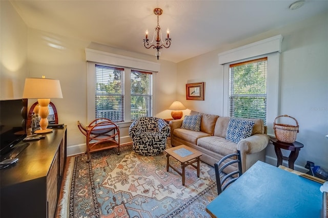 living room with an inviting chandelier, hardwood / wood-style flooring, and a wealth of natural light