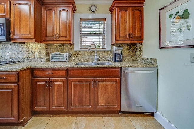 kitchen with backsplash, stainless steel appliances, sink, and light tile patterned floors