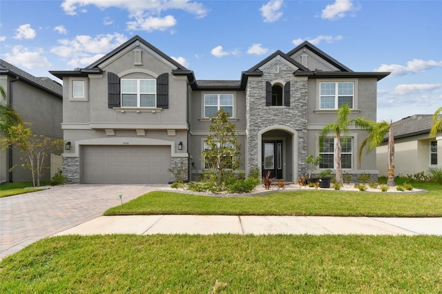 view of front of house featuring a garage and a front lawn