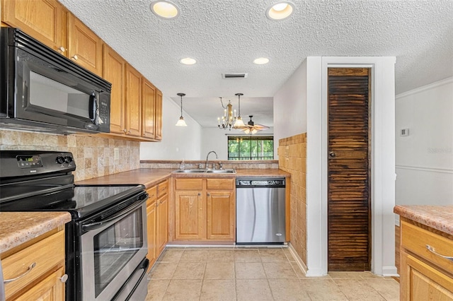 kitchen featuring black appliances, sink, a textured ceiling, pendant lighting, and light tile patterned floors