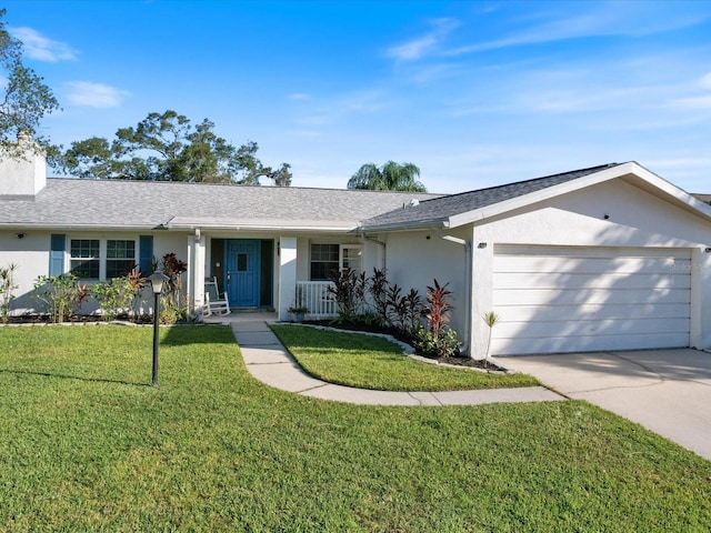 ranch-style home with a front lawn and a garage