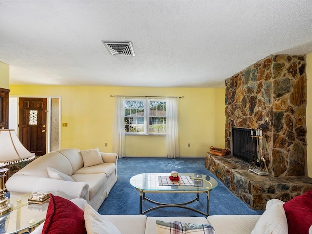 carpeted living room featuring a textured ceiling and a fireplace