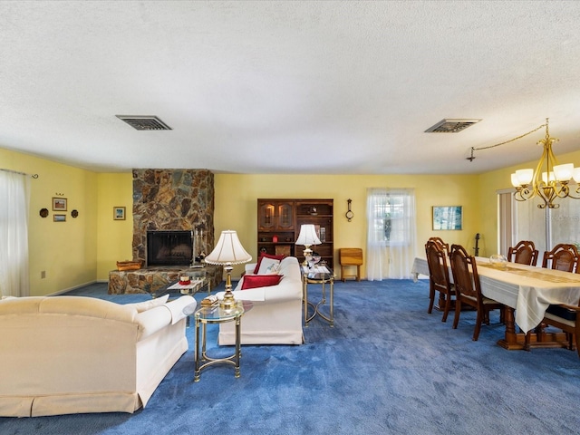 carpeted living room with a textured ceiling, a notable chandelier, and a fireplace