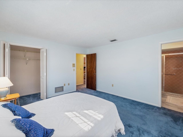 bedroom featuring dark colored carpet, a textured ceiling, and a closet