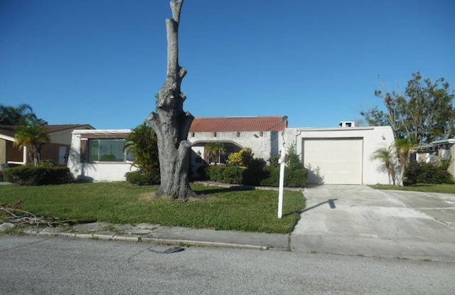 view of front of home with a front lawn and a garage