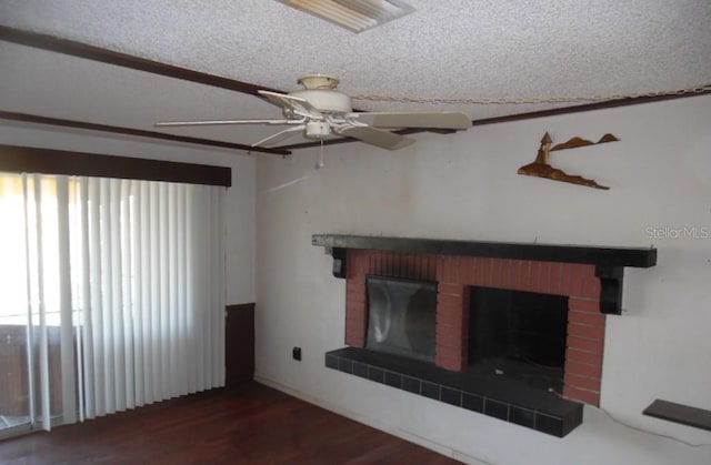 unfurnished living room featuring a textured ceiling, ceiling fan, a fireplace, and dark hardwood / wood-style flooring