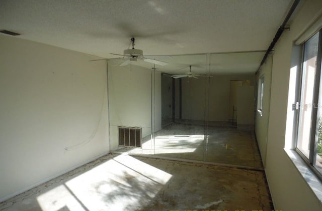 empty room with a healthy amount of sunlight and ceiling fan