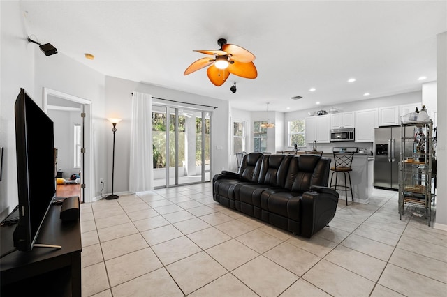 tiled living room featuring ceiling fan