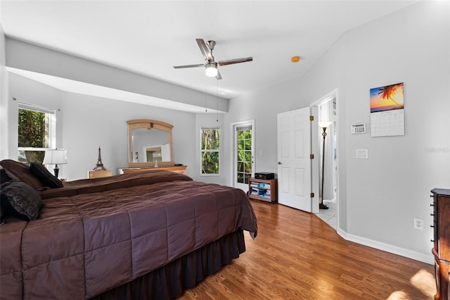 bedroom featuring multiple windows, light wood-type flooring, and ceiling fan