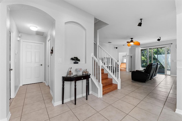 interior space featuring ceiling fan and light tile patterned floors