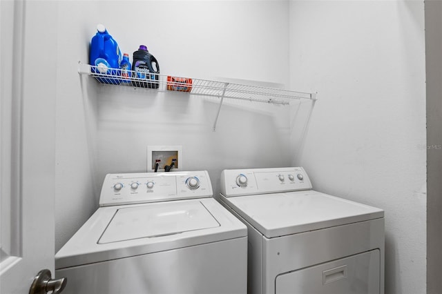 clothes washing area with washer and clothes dryer