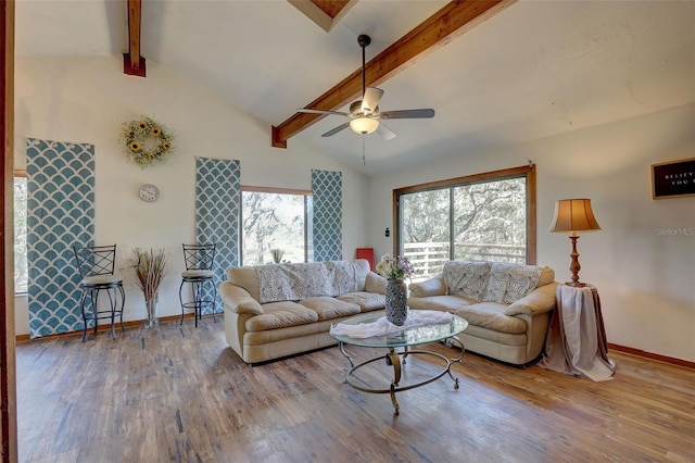 living room featuring vaulted ceiling with beams, ceiling fan, baseboards, and wood finished floors