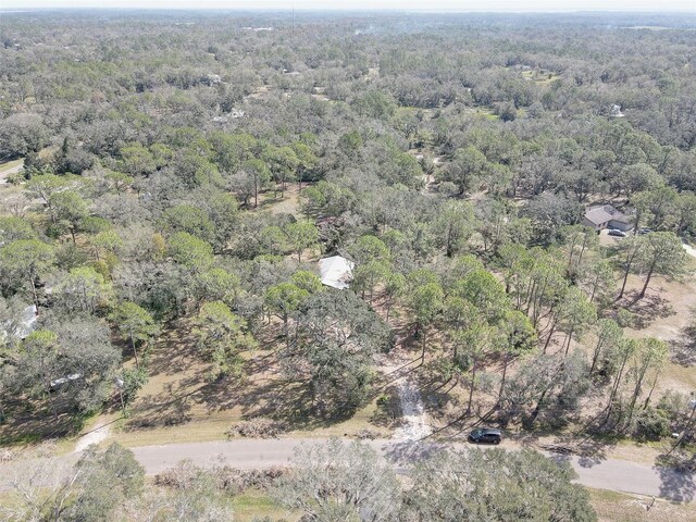 birds eye view of property with a forest view