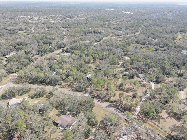 birds eye view of property with a view of trees