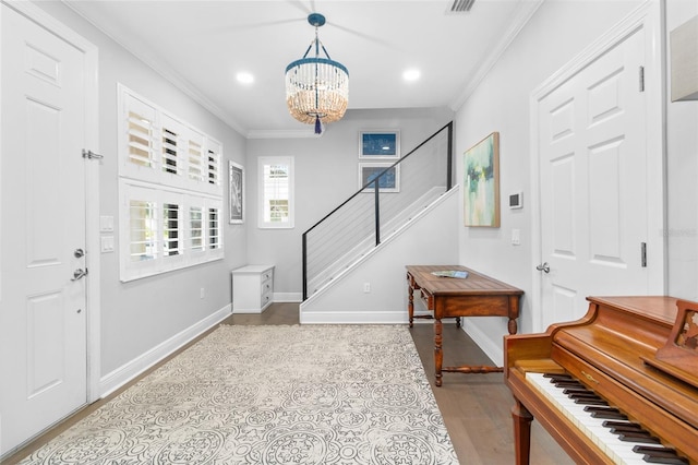 foyer with ornamental molding and a notable chandelier