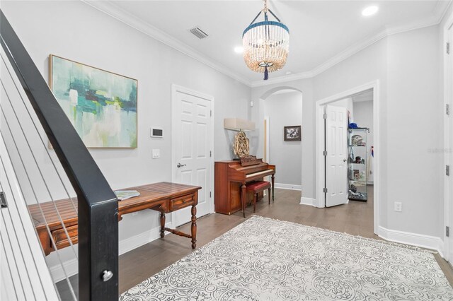 interior space featuring crown molding, hardwood / wood-style flooring, and a chandelier