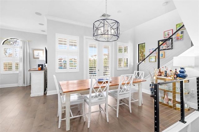 dining space featuring crown molding, a notable chandelier, and dark hardwood / wood-style flooring