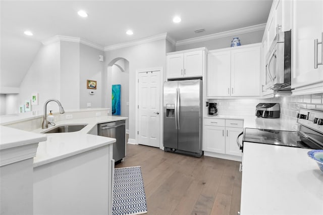 kitchen with appliances with stainless steel finishes, white cabinets, sink, and light hardwood / wood-style floors